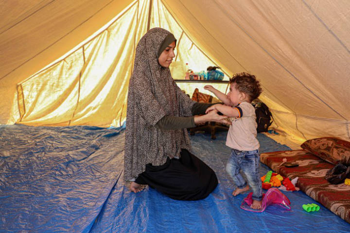 A woman and her child in a tent
